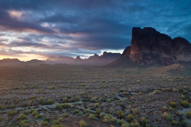 The Eagletail Mountains Wilderness in Arizona, with a cloudy horizon in the background and mountains in the foreground.