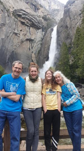 Margaux (second from left) with Peggy Cranston (far right) and Peggy’s family standing in front of a waterfall. 