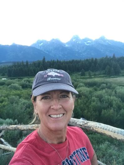 Michelle Waltman with a field and mountain in the background
