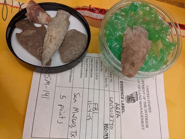 Two dishes with artifacts in them next to a BLM "evidence label" form