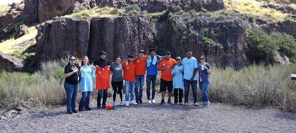 A group of 11 students and staff pose for a photo.