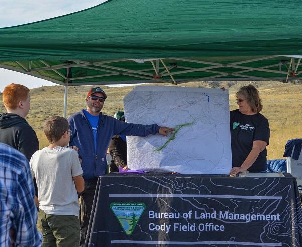 BLM Wildlife Biologist Destin Harrell points out on a map to volunteers where the Carter Mountain pronghorn herd travels.