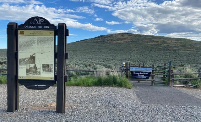 Ruts Access site showing interpretive signage, sky, and hilly landscape