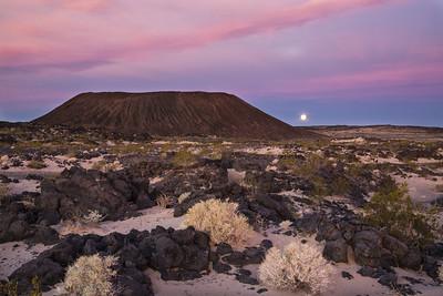 Large plateau with the moon rising in the background. 