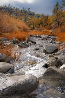 Stream through fall foliage.