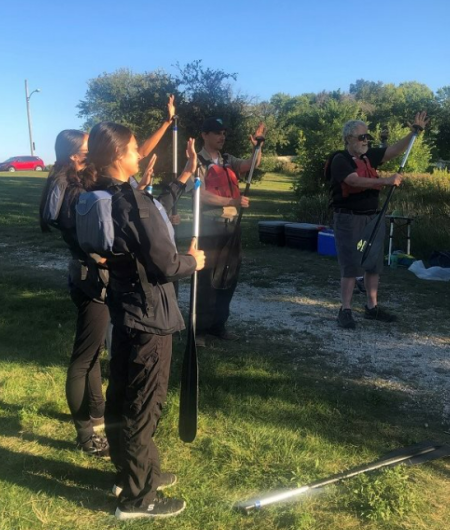 A group, including Lindy Nelson, Assistant District Manager for Natural Resources, gathers to take the Junior Ranger pledge at Lincoln Creek Park in Milwaukee, Wisconsin. (Photo by Martha Malik)