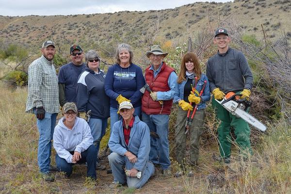 Nine people pose for a group photo. 