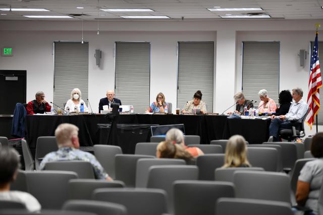 A conference with an audience and a panel of board members