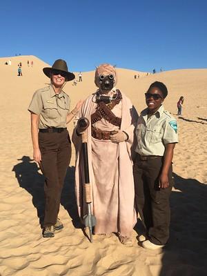 BLM employees pose with characters from Star Wars in the Desert. 