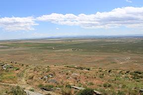 View from a cliff overlooking flat lands. 