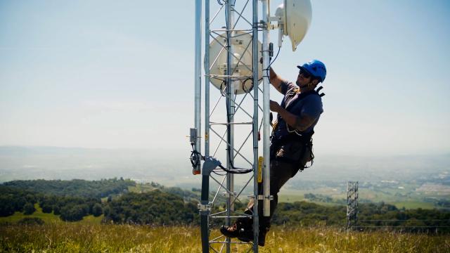 technician scaling a remote fire camera tower