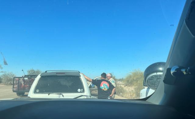 Dashcam view of officers assisting with a medical issue.