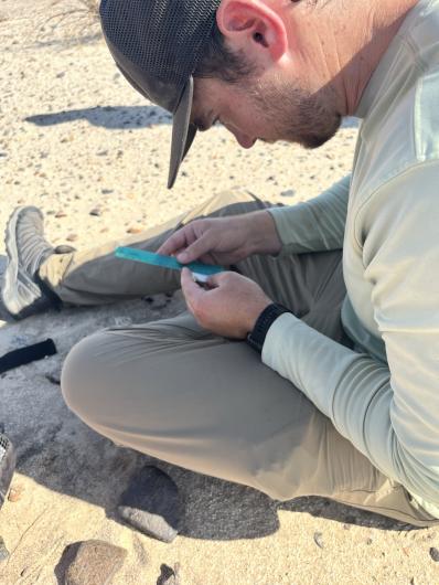 Wildlife biologist Peter Dejongh records data on a flat-tailed horned lizard