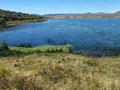 Boulder Reservoir. A body of water in a grassland.