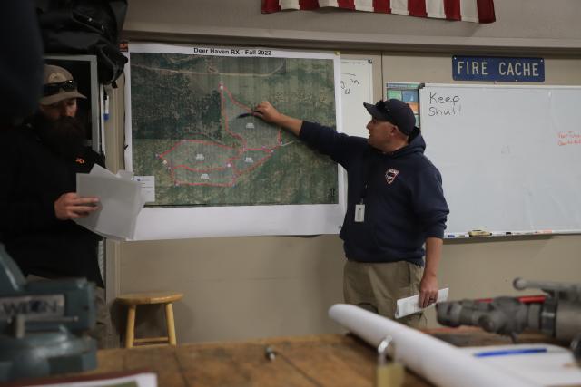 The briefing included detailed analysis of the burn sectors, as well as technical instructions for adapting to the day's anticipated conditions. (Photo courtesy of the BLM)