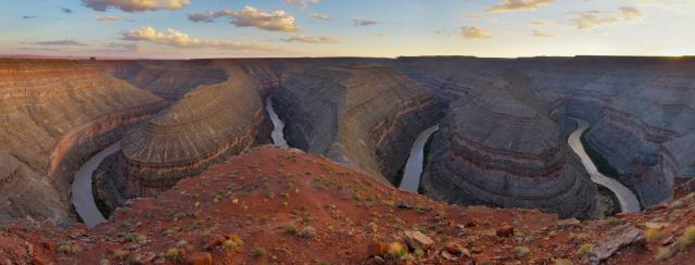 The San Juan River snakes in steep curves through deep canyons of red sandstone.