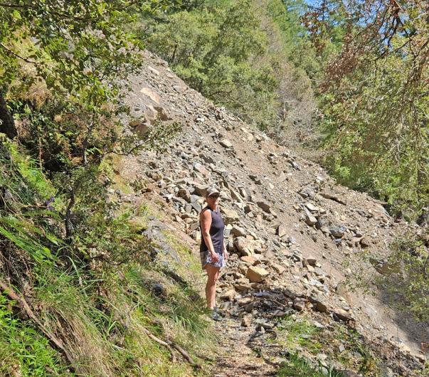 A BLM employee sizes up the landslide located on the Rogue River Trail approximately one mile upstream from the Rogue River Ranch