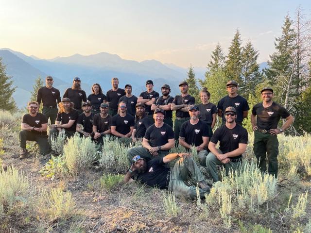 A group photo of the Bonneville Interagency Hotshot Crew with a mountain landscape in the background. | Photo Credit: National Interagency Fire Center