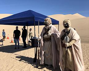 Two Star Wars characters in the desert.