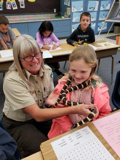 Ranger Tammy and Kolbie the California Kingsnake visit all the classes participating in the program. Students learn why we don't take animals from the wild, not to release pets into the wild, and that we don't have to kill animals that we are afraid of.