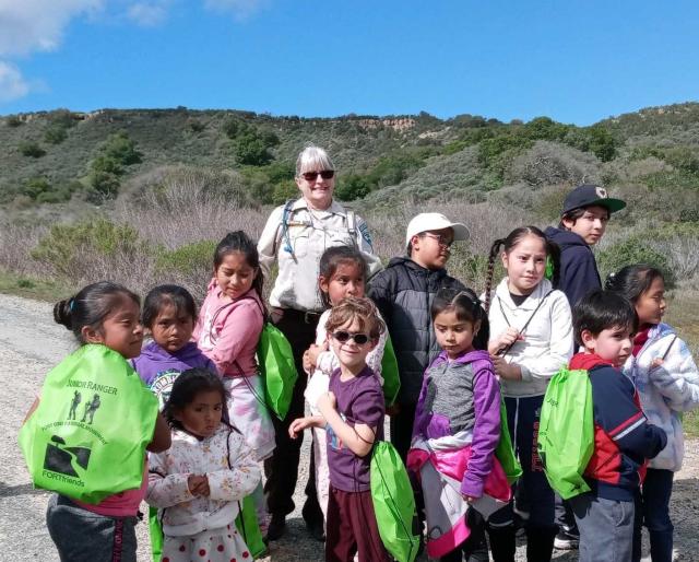Students return from the Saturday hike and receive Junior Ranger supplies (backpacks, water bottles and bandannas)  provided by Fort Friends. 