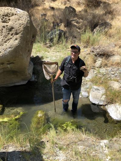Michael Westphal on BLM lands in Arroyo Leona with a net, holding a Southwestern Pond Turtle. 