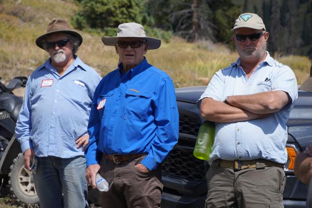 SWRAC member and two BLM employees listen to a discussion on a field trip.