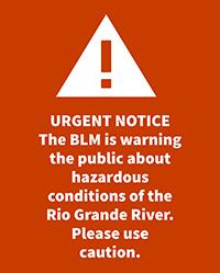 A warning sign urging hazardous conditions on the Rio Grande River.