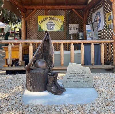 A replica of a cabin with the face of Smokey the Bear