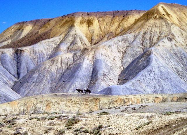 Horse riders in the adobe badlands of Gunnison Gorge NCA.