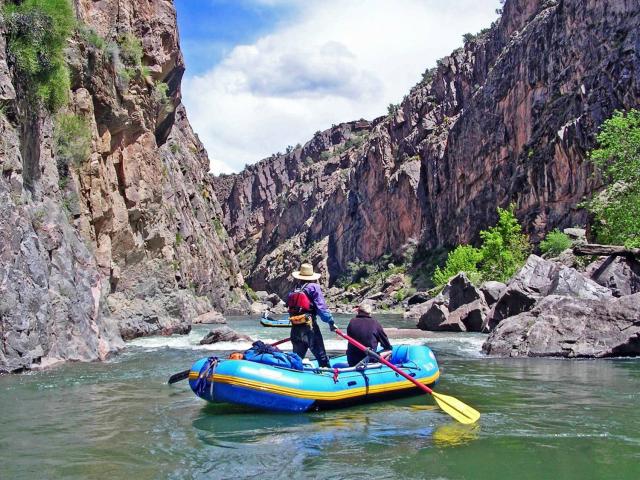 Rafters paddle through a calm section of the Gunnison Gorge.