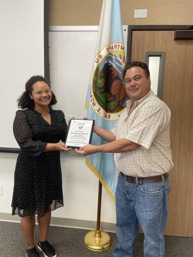 Chelsea Collins receives award from Michael Vermeys, Assistant FM for PSSC_Photo by BLM