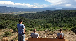 Several people sitting on a bench. 