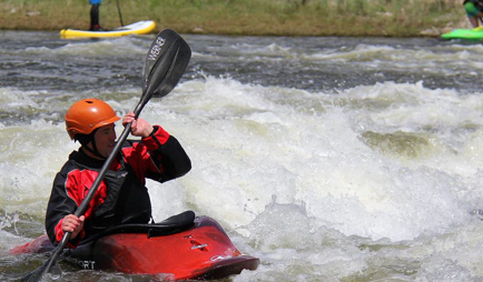 A man riding a kayak. 