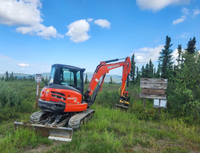 A mini-excavator at a BLM trailhead