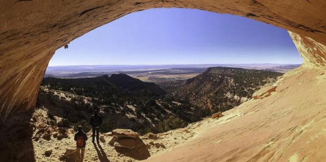 Utah desert arch frames a hilly panorama