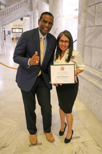 Anayanci poses with Congressman Burgess Owens while holding her certificate of recognition.