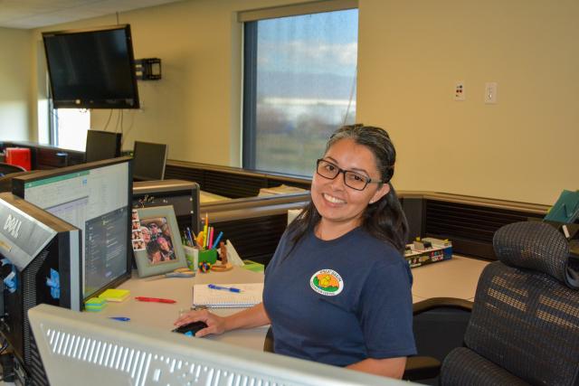 Anayanci sitting at her desk at the Great Basin Coordination Center.