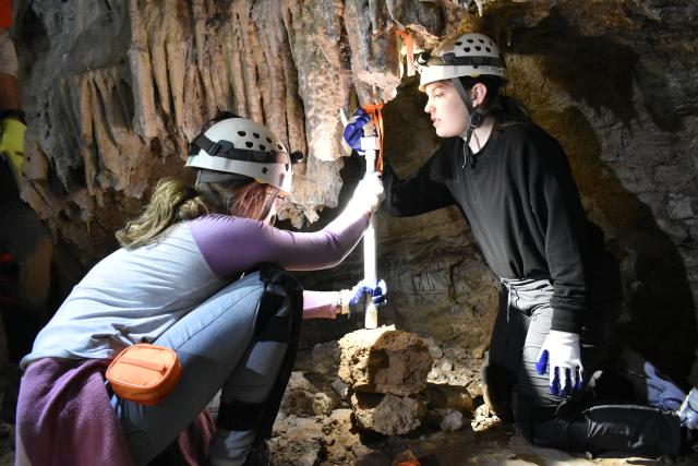 Everis J., left, and Kaylee G., Girl Scout Cadettes from Troop 10655 in Albuquerque, N.M., use a Stalactijack to repair a stalactite in McKittrick Cave near Carlsbad, N.M., Nov. 25. Everis spearheaded the cave restoration project to earn the Girl Scout Silver Award, one of the highest Girl Scout awards.