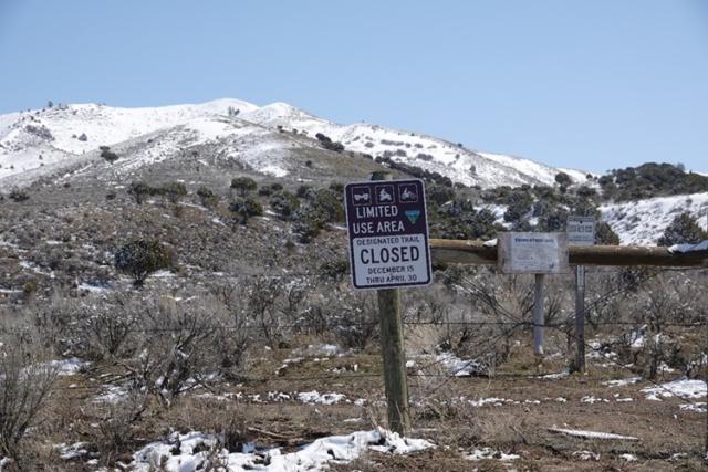 A temporary closure sign limiting human access and vehicle traffic to the Stinking Springs area to protect wildlife.