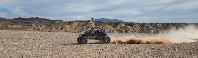 Off Highway Vehicles driving through desert.