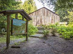A wooden building and a trail sign.