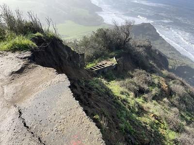 a trail along the Pacific Ocean sliding down a large cliff.