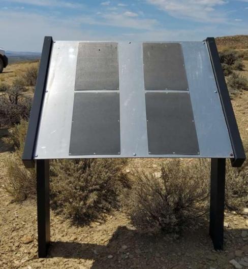 Alt Text: The photo shows a large metal sign with four braille panels interpreting the Superior Mail Arrow site on BLM land.