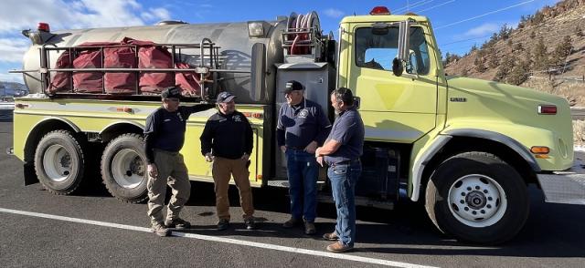 Bureau of Land Management employees transferring a water tender to the Wheeler County Rangeland Fire Protection Association