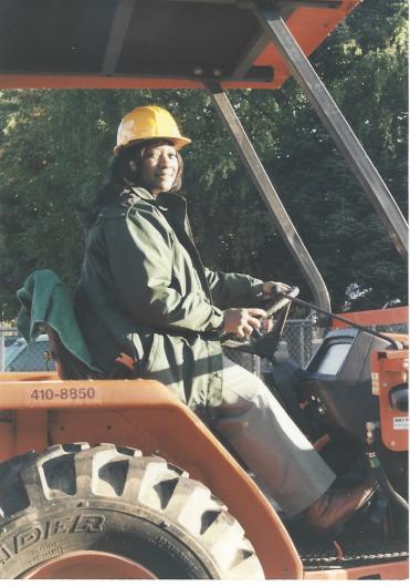 Gloria Brown using heavy machinery to do her work