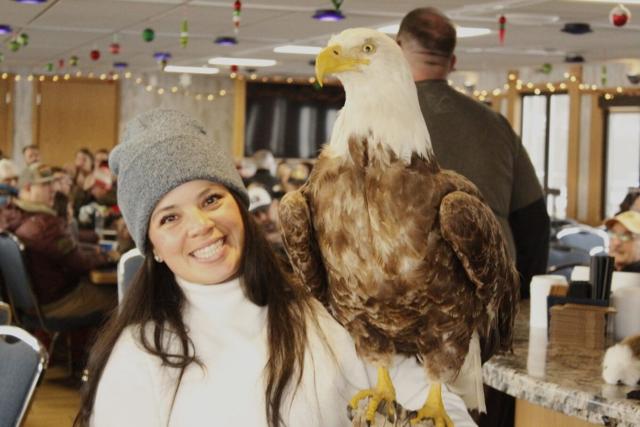Volunteer, Alexa Oyola, shows off a taxidermy American Bald Eagle to the group. (photo by MTG)