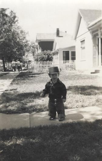 Photo shows Rugwell as a toddler standing on a sidewalk in Cheyenne, Wyoming.