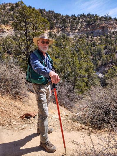 Doug Page walks with a hiking stick.