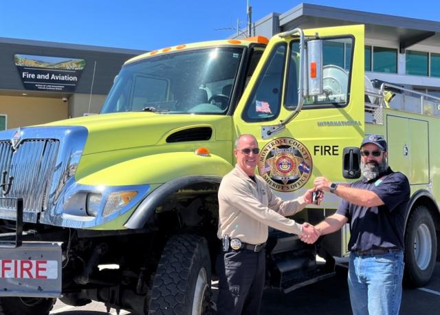 Southwest Fire FMO Brandon Lewis turns over the keys to a Type IV wildland fire engine to Montrose County Emergency Manager Scott Hawkins.